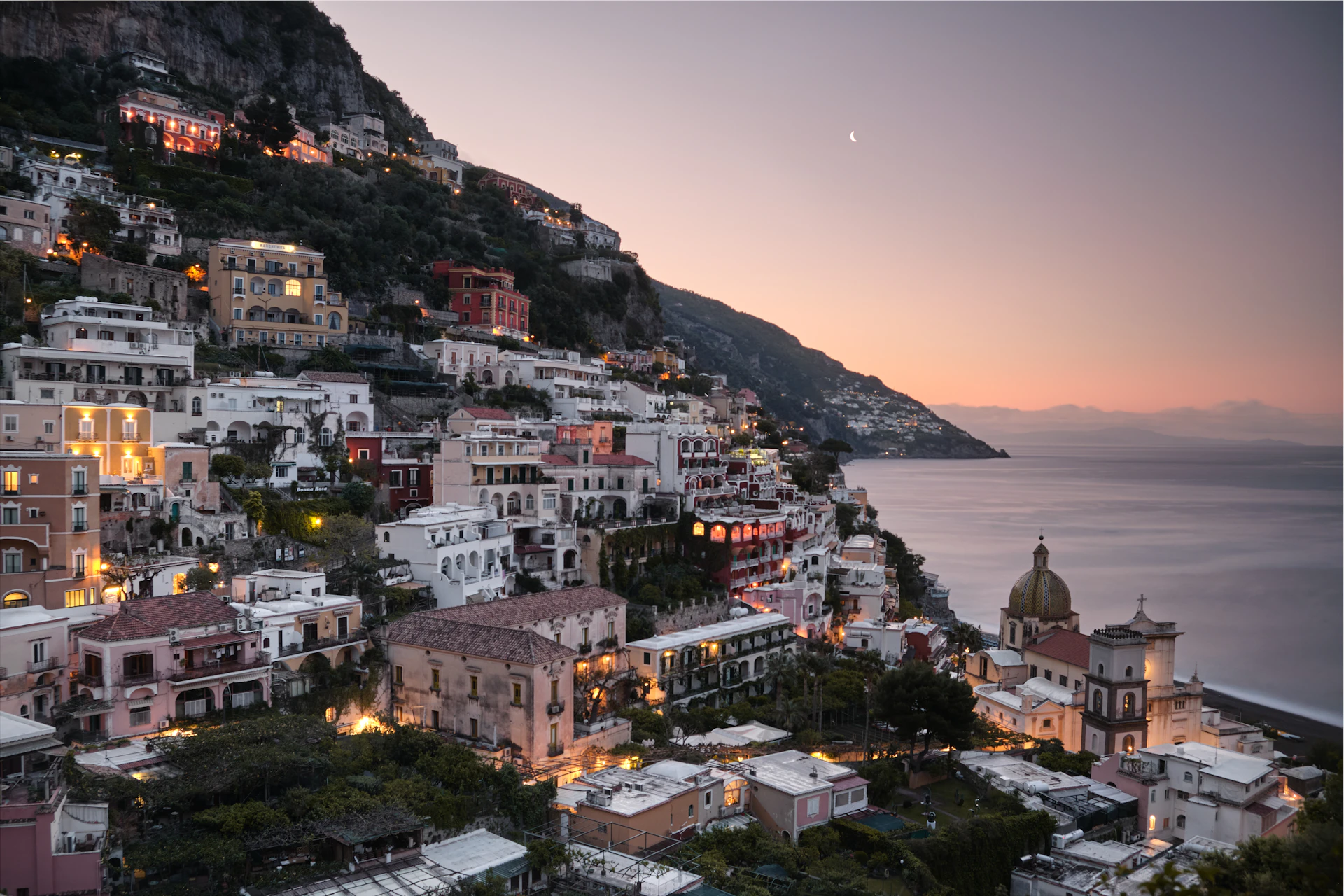 Cliffside homes above the Amalfi Coast at dusk