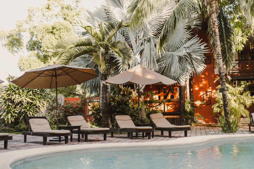 Refined pool terrace surrounded by lush tropical gardens